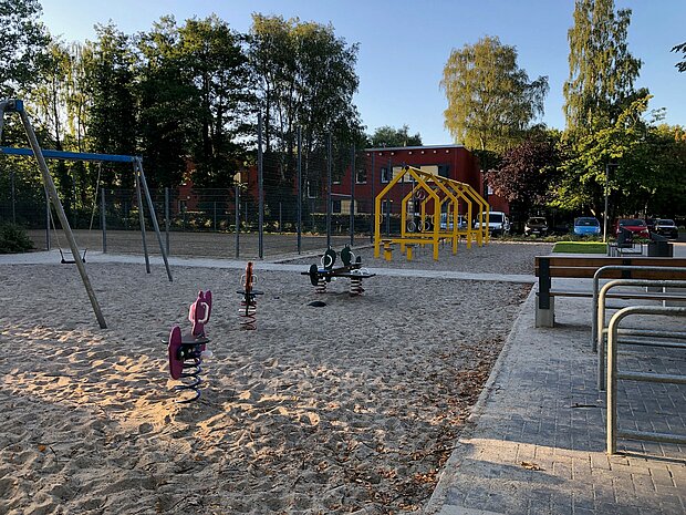Blick auf einen Spielplatz mit verschiedenen Spielgeräten.